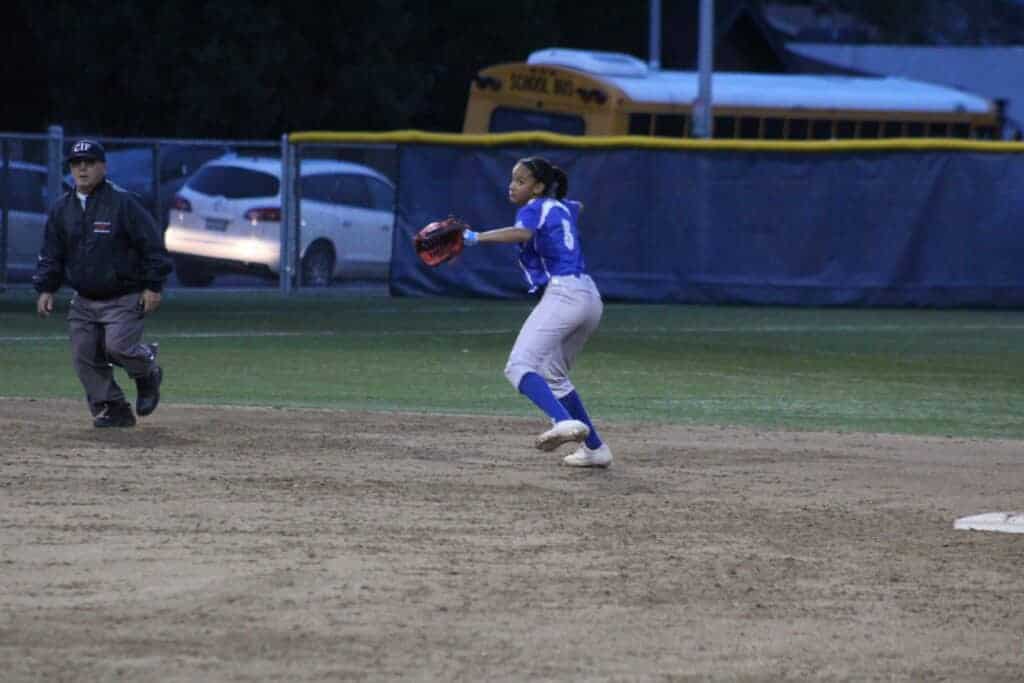 Photo - Madera shortstop Lealani Ricks makes the long throw across the diamond for an out during Monday’s loss to Stockdale.
