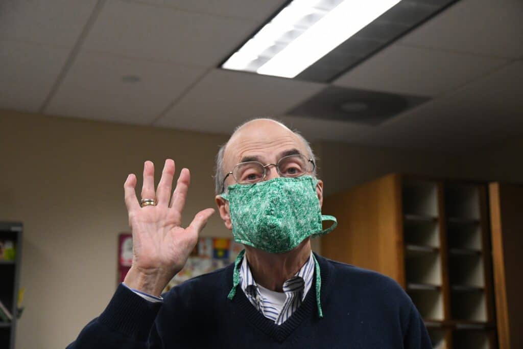 Photo - Chuck Doud, donning his own PPE (Personal Protecive Equipment).