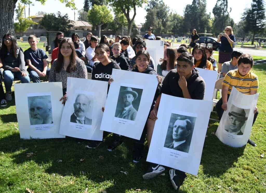 Photo - Madera Unified School district students hold posters of past Madera County Sheriffs during a presentation for “Outlaws and Lawmen: Crimes of the Century and the Madera County Sheriffs who Solved Them.”