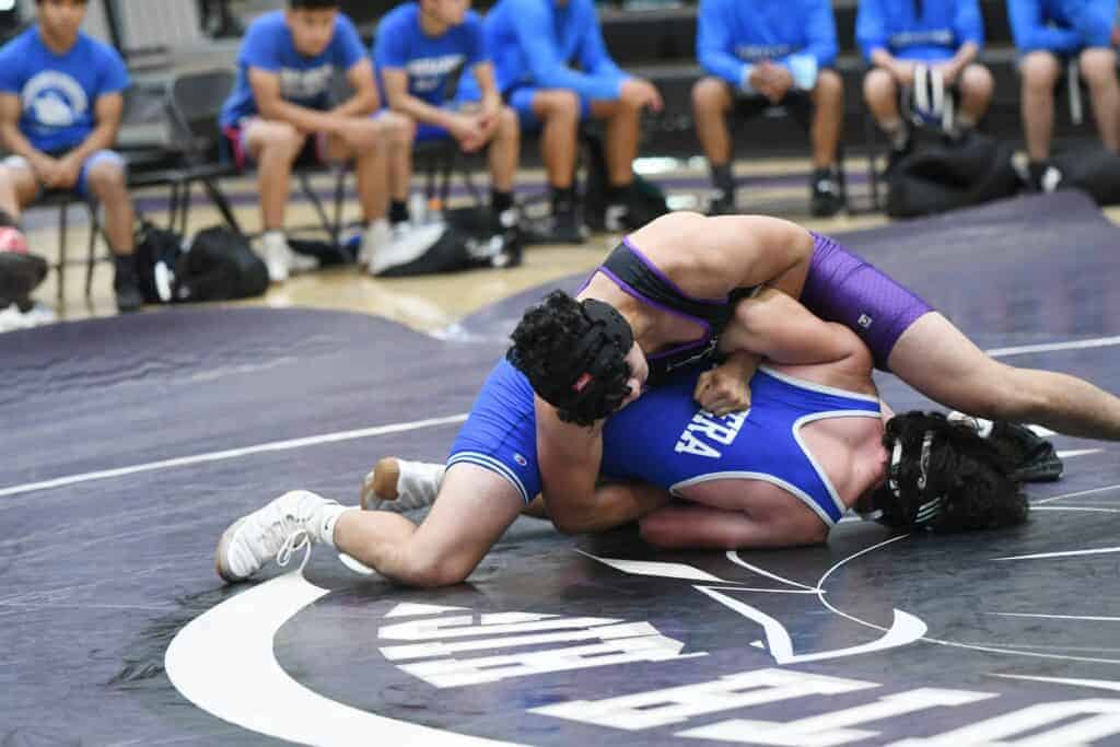 Photo - Madera South 195-pounder Angel Castel works Madera’s Carson Brunolli over to receive near fall points. He opened Tuesday’s dual with a victory to help the Stallions to a team win over the Coyotes.