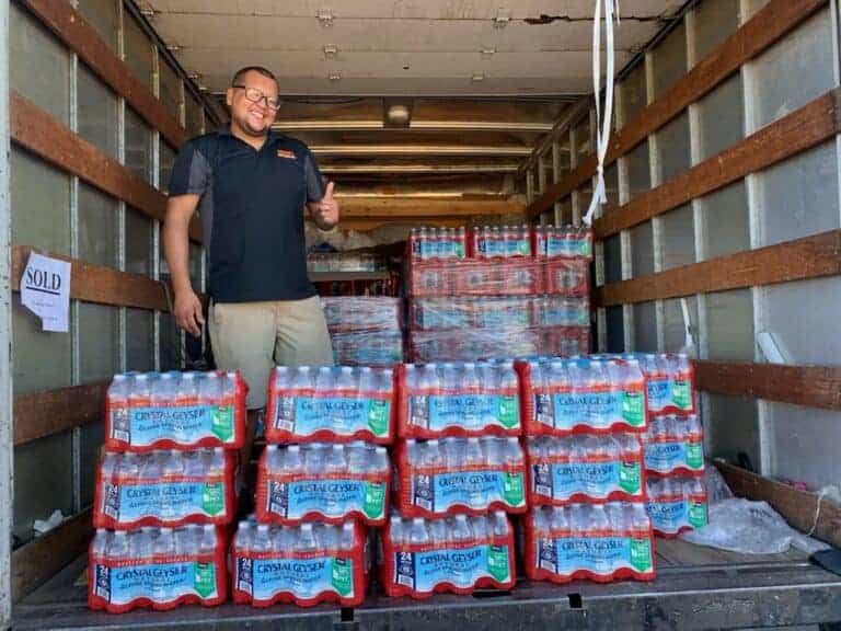 Business owner gives away cases of water