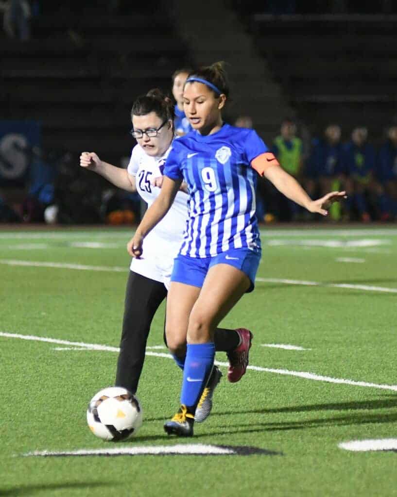Photo - Madera South’s Destiny Pursell defends against Madera midfielder Mia Alvarez during Wednesday’s match. Alvarez scored the eventual game-winning goal for the Coyotes.