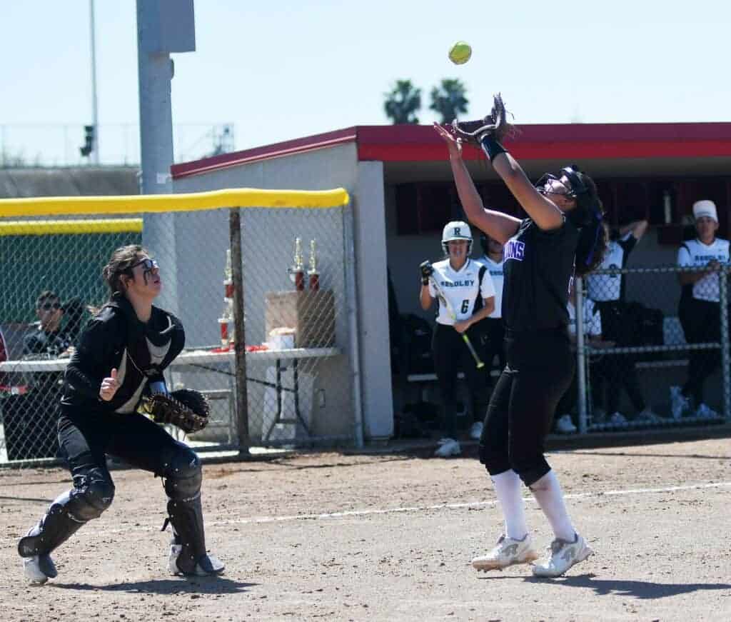 Photo - Madera South catcher Margarita Rascon watches pitcher Erica Valdez catch a pop up in the fifth inning of Tuesday’s victory over Reedley in the Kerman Easter Classic.