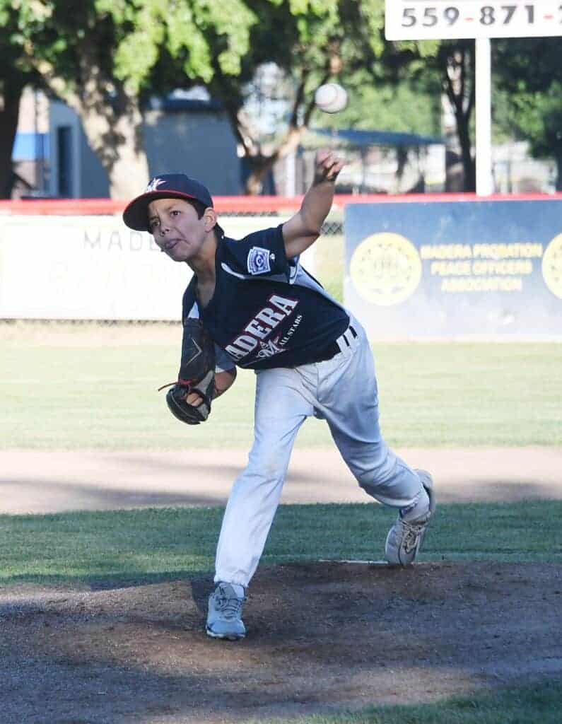 Photo - Madera American’s Frankie Espejo throws a pitch in a 6-4 victory over Madera National. Espejo was the winning pitcher, tossing five innings with nine strikeouts.