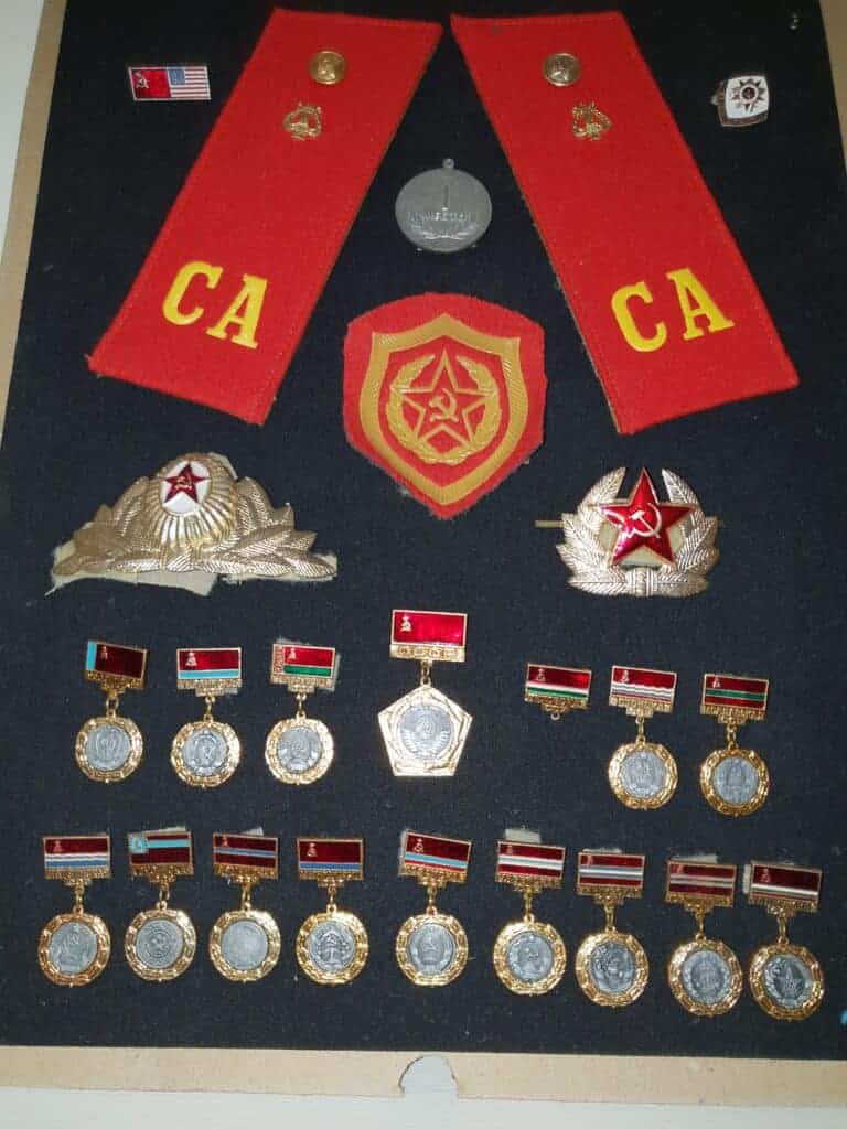 Photo - This homemade shadow box features many souvenirs from CWO Kirk Edwards’ trip to Leningrad. It features shoulder boards from a Soviet Army uniform, a shoulder patch, plus hat devices.
