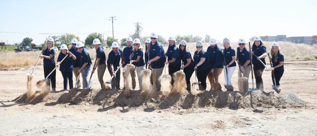 Photo - The future staff of the new Madera Unified School District Concurrent Enrollment Middle School turn up the ground where the new facility they will be working at will be.