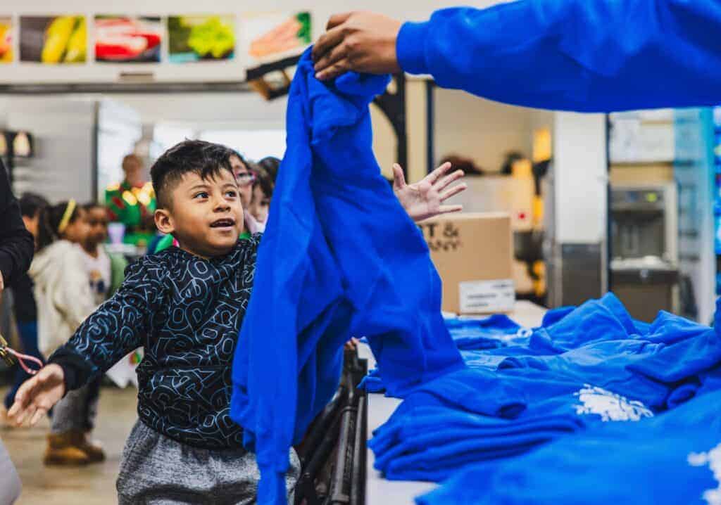 Photo - James Madison Elementary School Students receive a sweatshirt, courtesy of Pacific Farm Management, Cal-Pacific Supply and Valley Stealz.