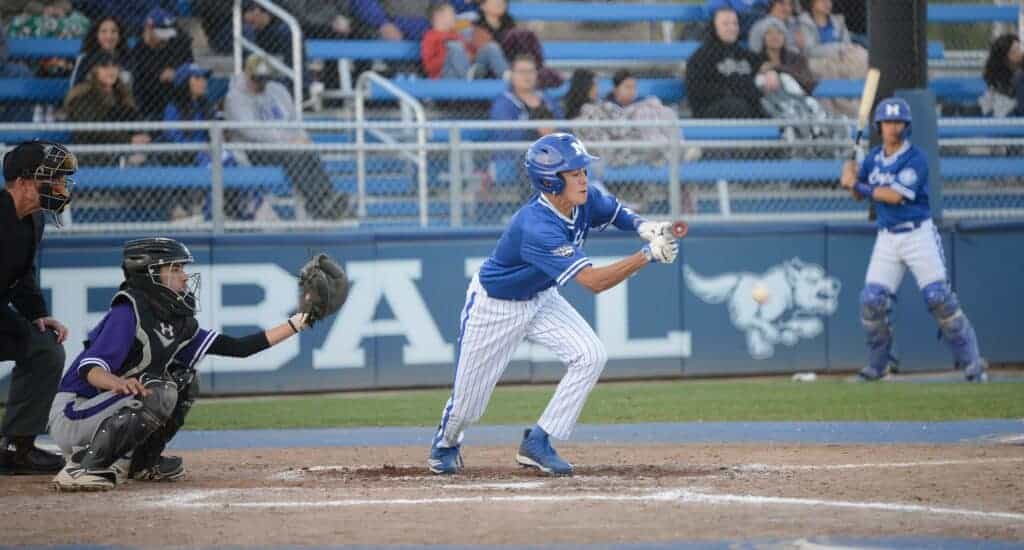 Photo - Madera’s Jonathan Ramirez puts down a bunt for a base hit during Friday’s 14-2 victory over the Madera South Stallions.
