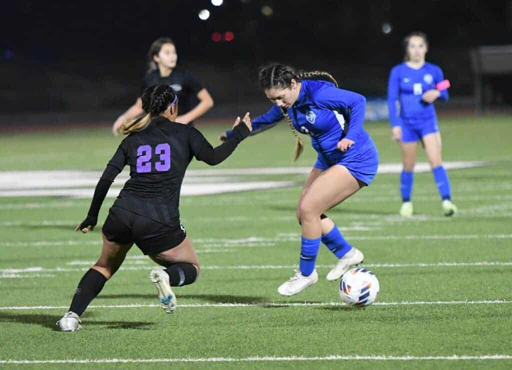Photo - Madera’s Atiana Piñon tries to work the balla round the defense of Madera South’s Kiana Ochoa during Friday’s 2-0 victory over the Stallions. Piñon scored a goal and assisted on the other.
