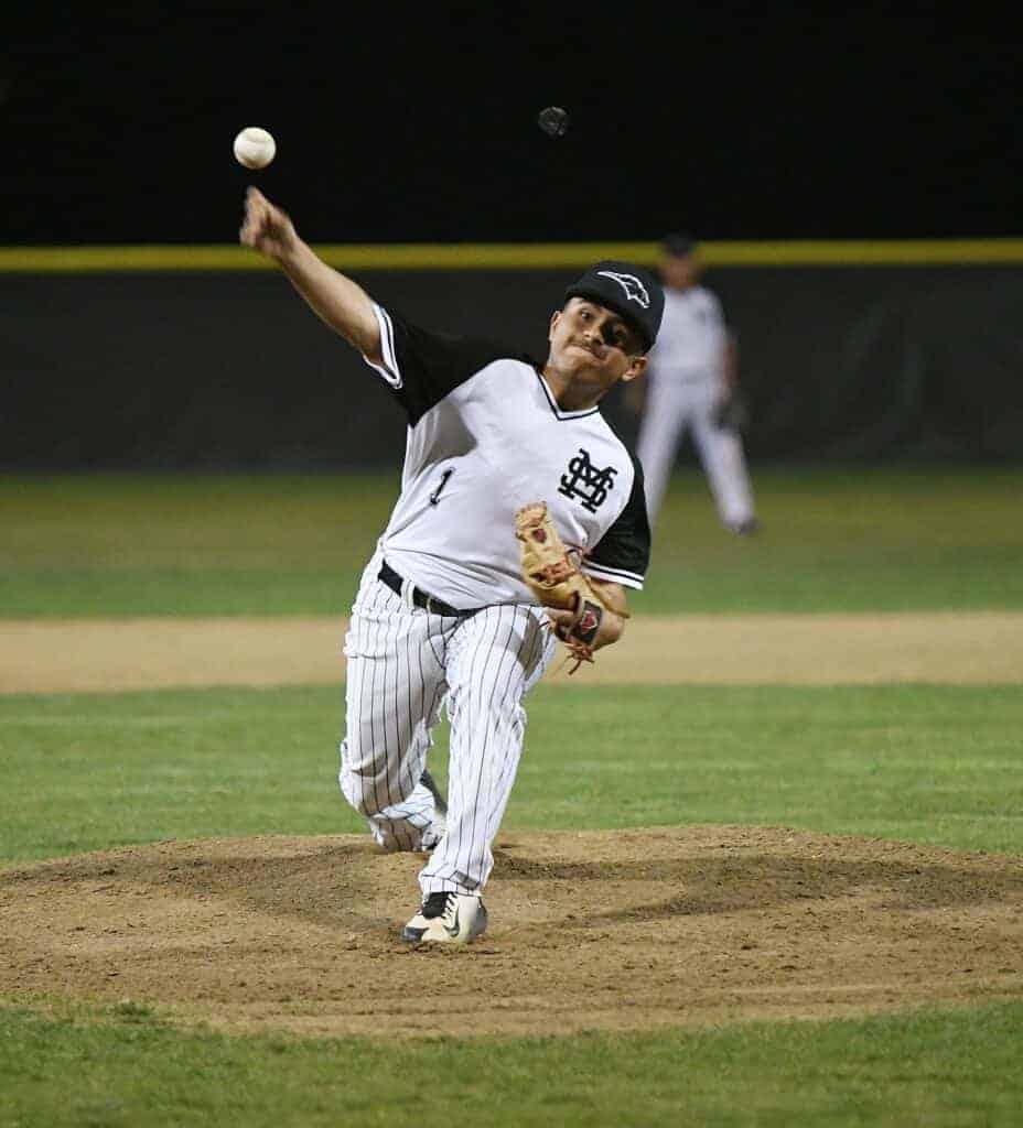 Photo - Madera South’s Brian Malagon throws a pitch during Wednesday’s loss to the Fowler Redcats.