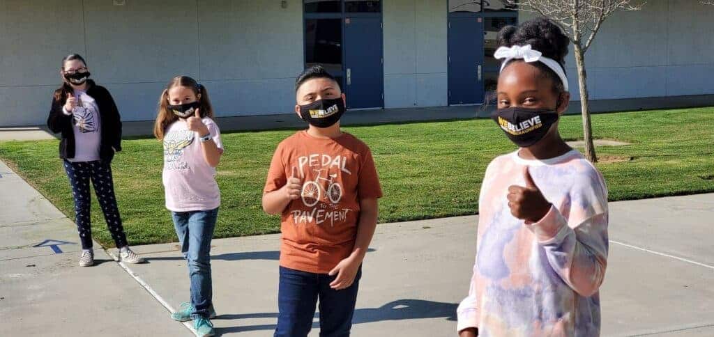 Photo - Students from Nishimoto Elementary pose in front of the bus drop-off area.