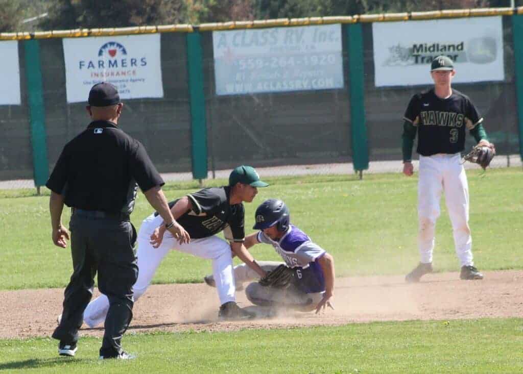 Photo - Liberty shortstop Jakson Bucher places a late tag on Madera South’s Anthony Gamiz on a stolen base attempt in the first inning of Saturday’s 8-6 Stallion’s victory.