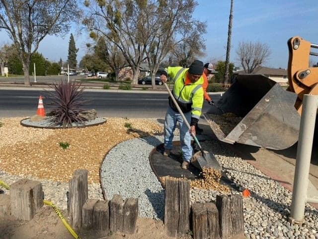 Photo - Madera City workers complete work in front of Lions Town and Counry Park as part of a drought-tolerant makeover that was designed by the city’s Jamie Hickman and Javier Valdez.
