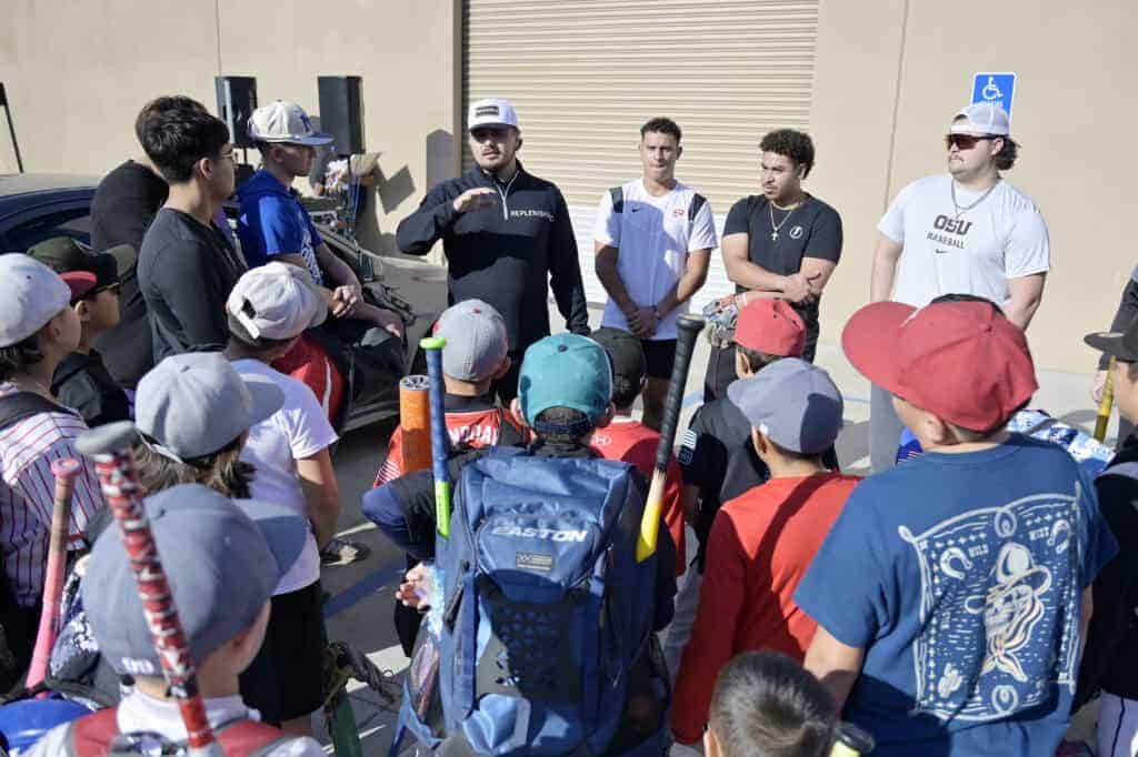 Photo of Cole Brincefield, owner of Replenished, a wellness and recovery center, talks with players during a baseball camp at the facility during a soft opening on December 20.