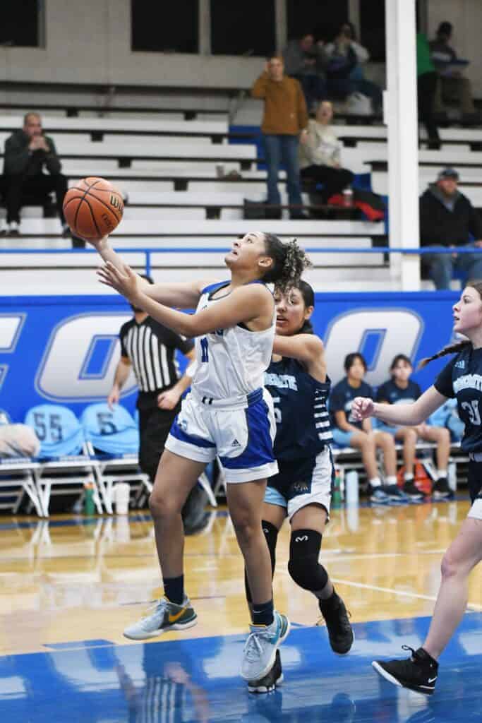Photo - Madera’s Rhynne Mitchell drives to the bucket to score two of her game-high 20 points in Friday’s rout over the Yosemite Badgers. She also had six steals and hit four 3-pointers. 