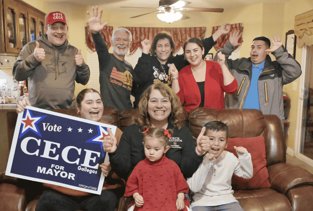Photo - Cece Gallegos is surrounded by family and friends during an elections watch party Tuesday. They cheer on the preliminary results that showed her leading the Madera Mayoral race over three other candidates.