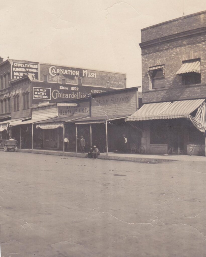 Photo - The Cottage Saloon, the Madera Restaurant, and the Bank Saloon are shown here between the two-story, brick buildings on south Yosemite Avenue between C and D Streets. The three single-story frame buildings went up in flames in 1918, and most Maderans said, “good riddance.”