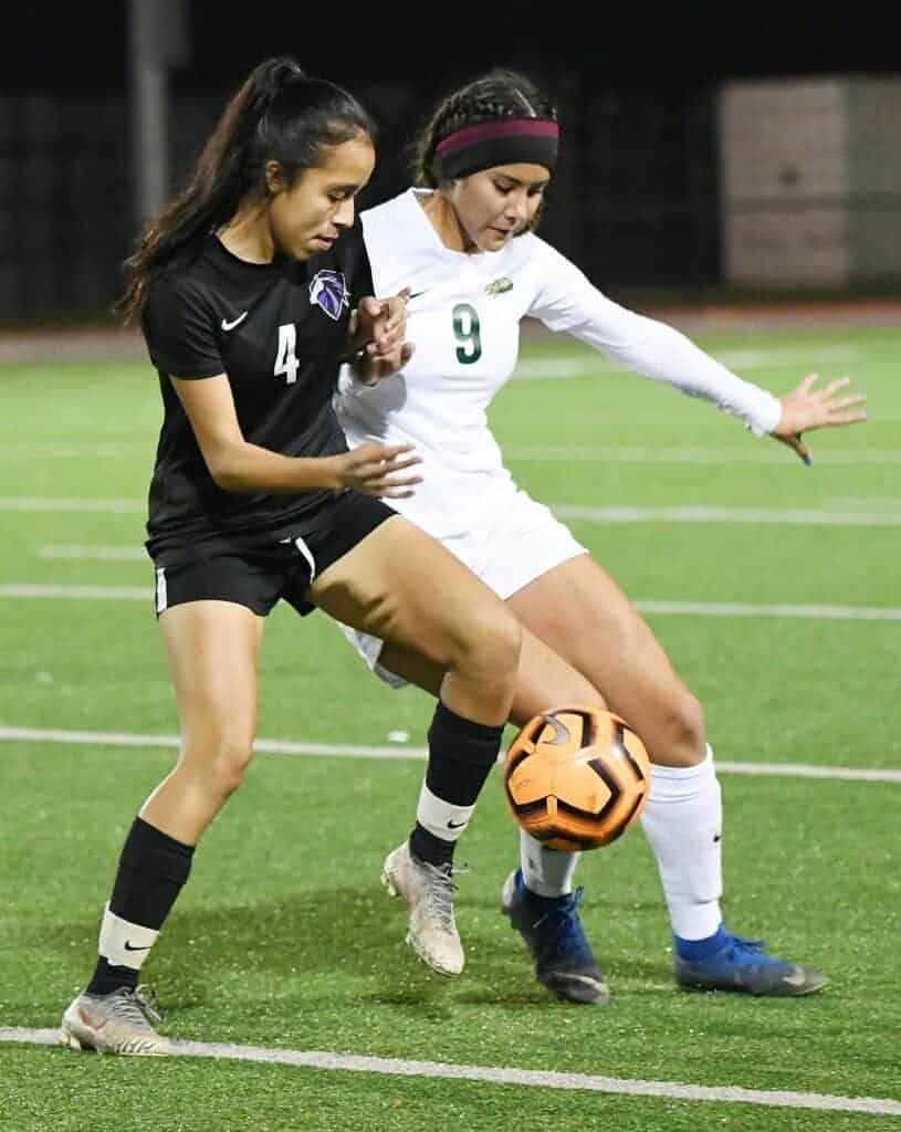 Photo - Madera South’s Aliah Avila (4) and Liberty’s Sara Garibay (9) battle for possession during Friday’s match.