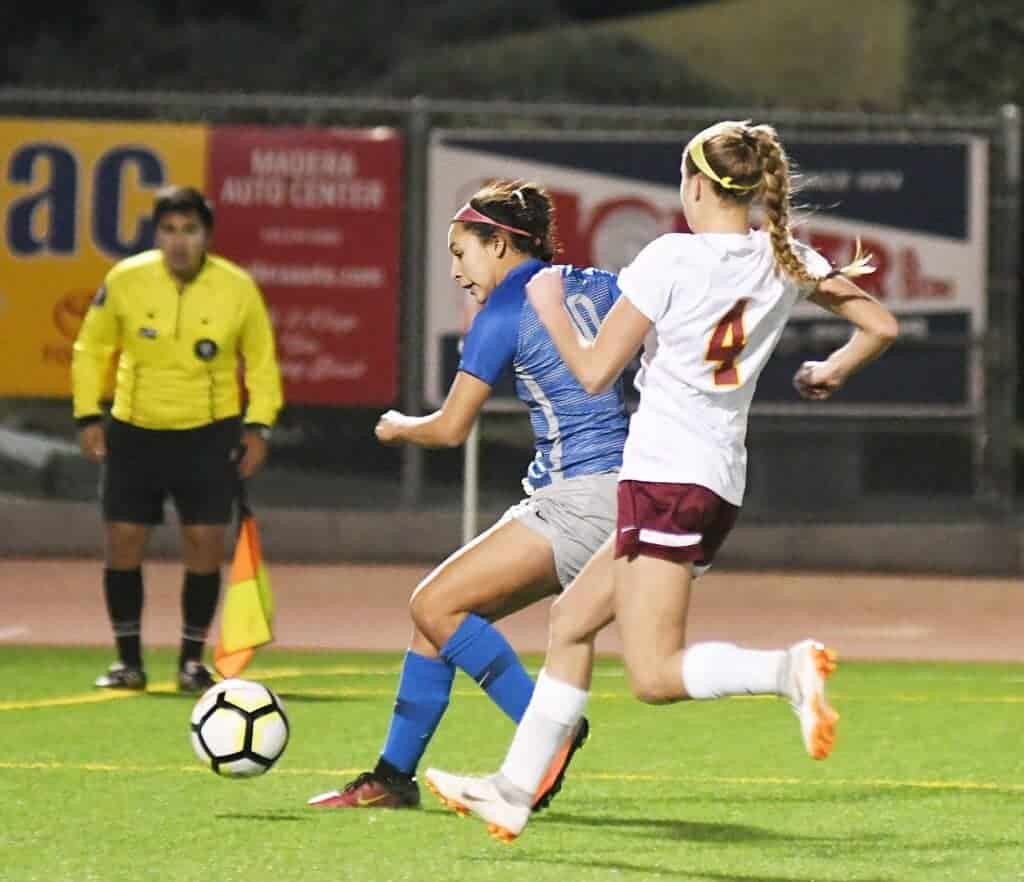 Photo - Madera’s Itzel Rodriguez follows her penalty shot miss by knocking in the rebound for her 10th goal of the season in a 3-1 loss to the Clovis West Golden Eagles.