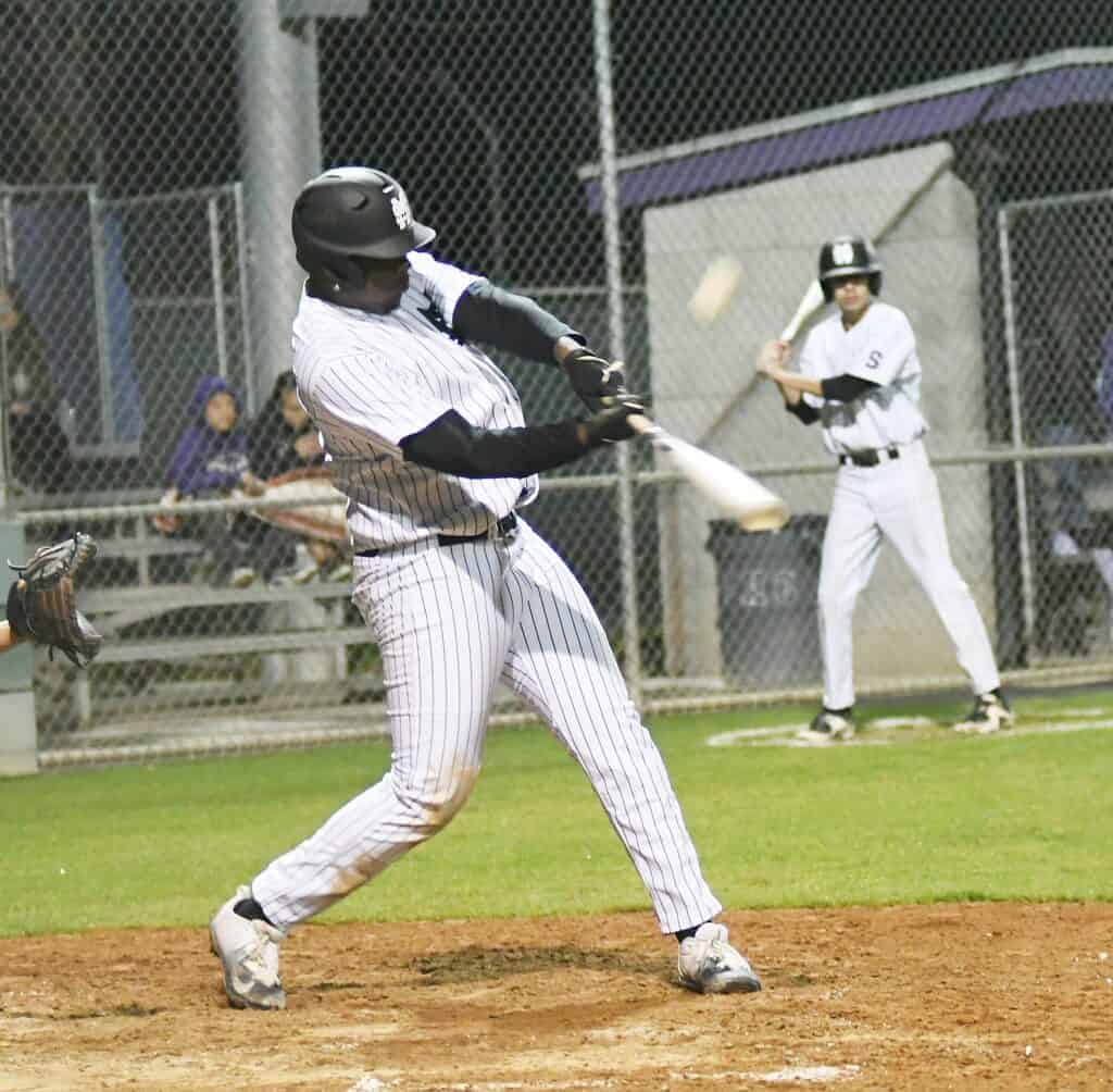Photo - Madera South designated hitter Kingsley Thomas lifts a fly ball to deep right-centerfield. The ball was flagged down by Firebaugh in Wednesday’s loss.