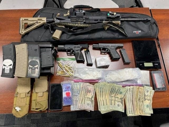 Photo - Madera Police shows off the items confiscated from the arrest of Oscar Montes Jr., including a stolen rifle and two handguns.