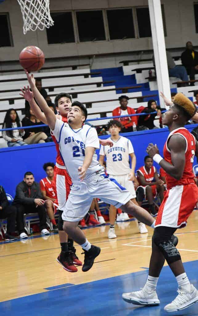 Photo - Madera’s Jesus Arzola drives the lane to score two of his team-high 10 points in a loss to McLane on Monday.