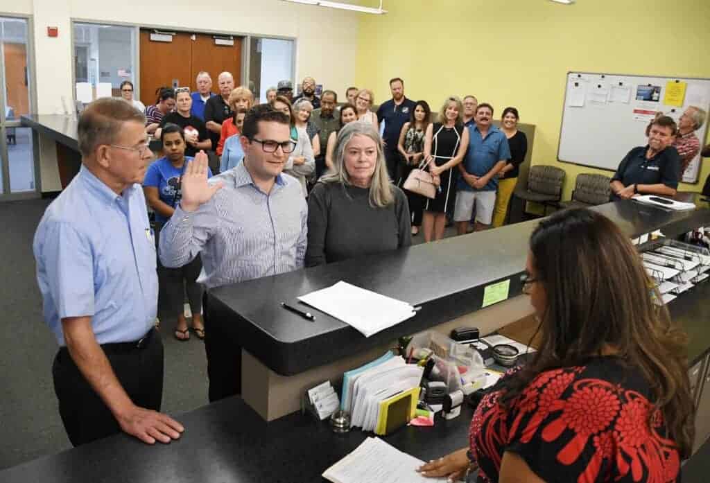 Photo - Family, friends and supporters gather as Sherri Carrillo of the Madera County Clerk-Recorder’s office administers the oath to Madera City Councilman Will Oliver last Wednesday as Oliver submits paperwork to run for re-election for District 3.