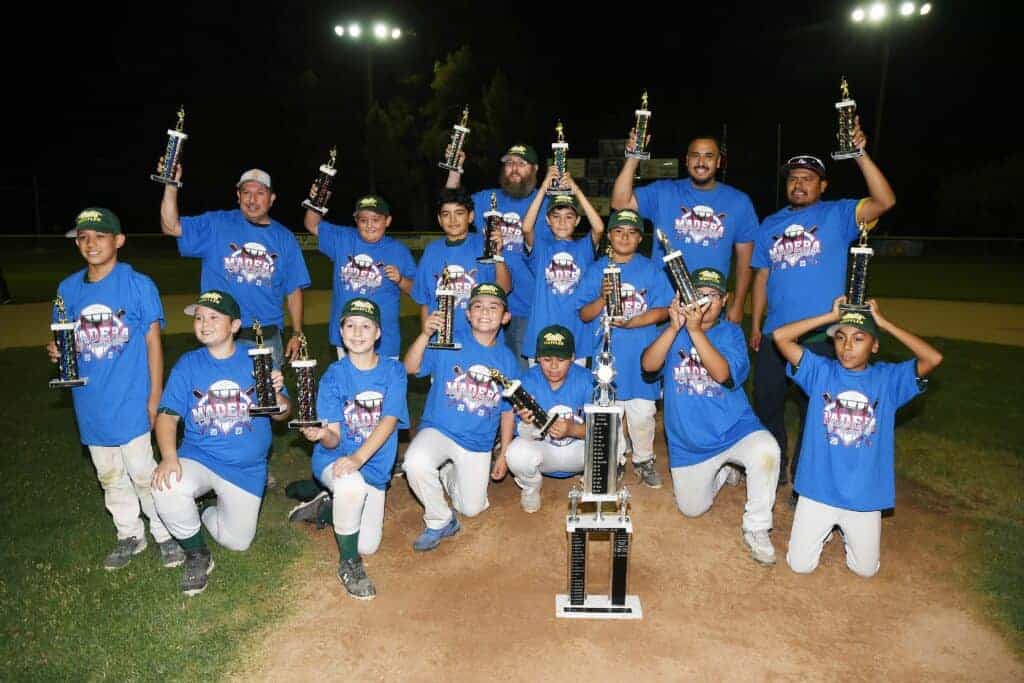 Photo - Madera American’s Holiday Muffler celebrates on the pitcher’s mound after its 8-6 victory over Fitzgerald, Alvarez and Ciummo in the Madera Little League City Championship game Saturday.
