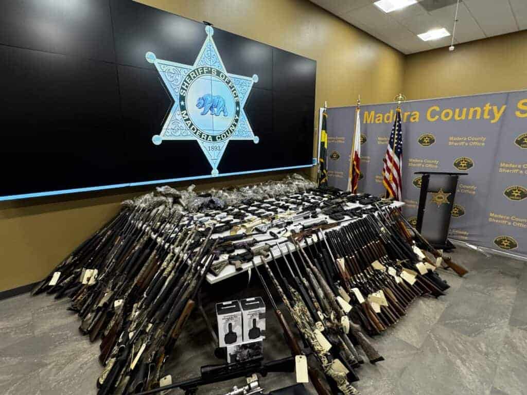 Photo - During a press conference last week, the Madera County Sheriff’s Office display some of the 163 firearms seized in the execution of a pair of search warrants the previous week.