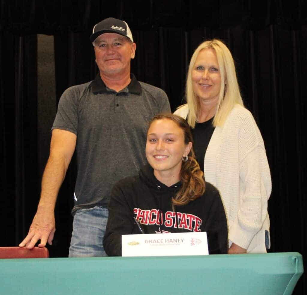 Photo - Liberty track star Grace Haney, and her parents, are all smiles after signing a National Letter of Intent to Chico State in May. 