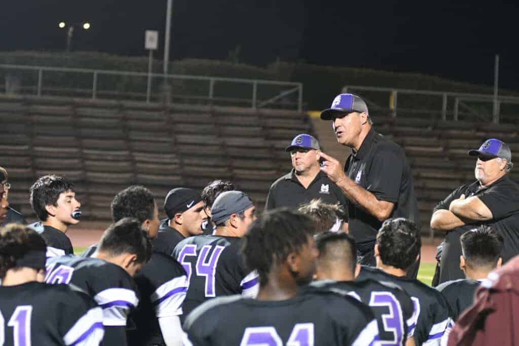 Photo - Madera South football coach Matt Johnson talks to his team that gave him his first Stallions victory after a 20-7 win over the Hoover Patriots in Memorial Stadium.