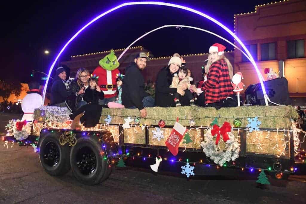 Photo - The Grinch tags along on the 1st Class Auto Repair float during the 2021 Madera Light Parade last year.