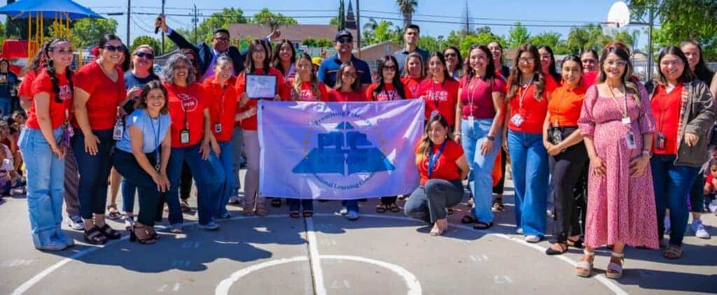 Photo - George Washington Elementary School staff celebrates getting recognized as a Promising Practices Learning Community at Work, a first for a dual-language school.