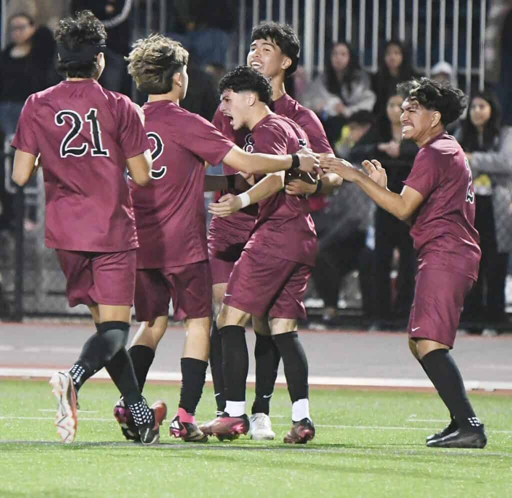 Photo - Toros boys soccer players surround Jese Gonzalez, right, after he scored the eventual game-winning goal in Saturday’s Div. V Central Section championship victory over Riverdale. 