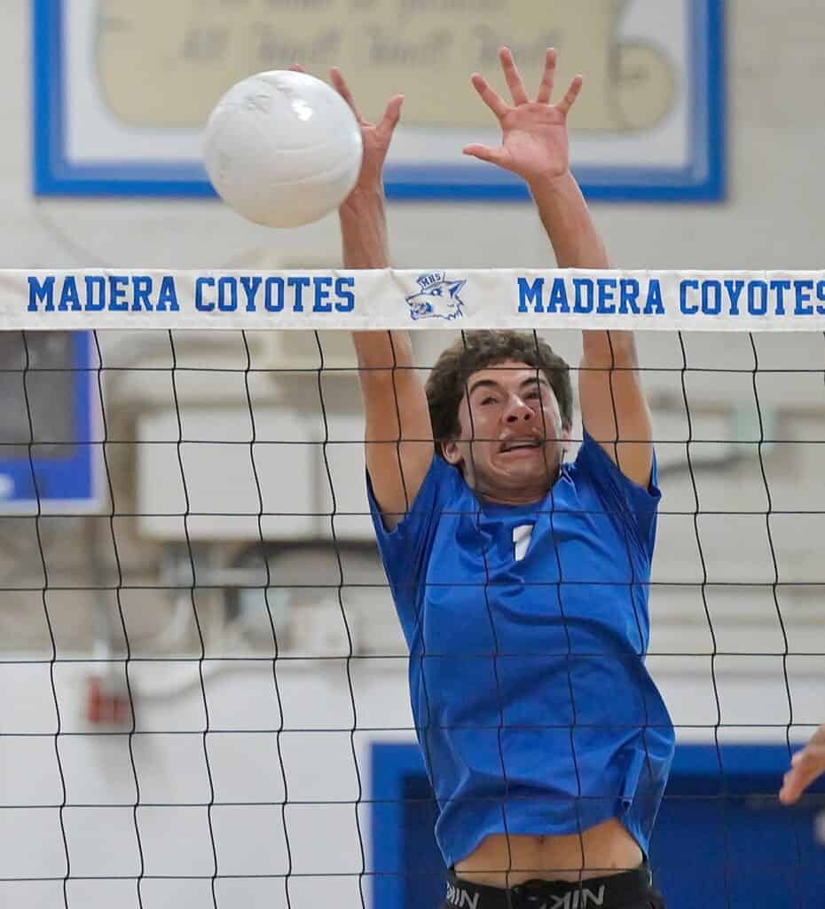 Photo - Madera’s Samuel McDonald rises up for a block during Thursday’s five-set win over Sanger West. McDonald led the Coyotes with 24 kills, including four in the deciding fifth set. 