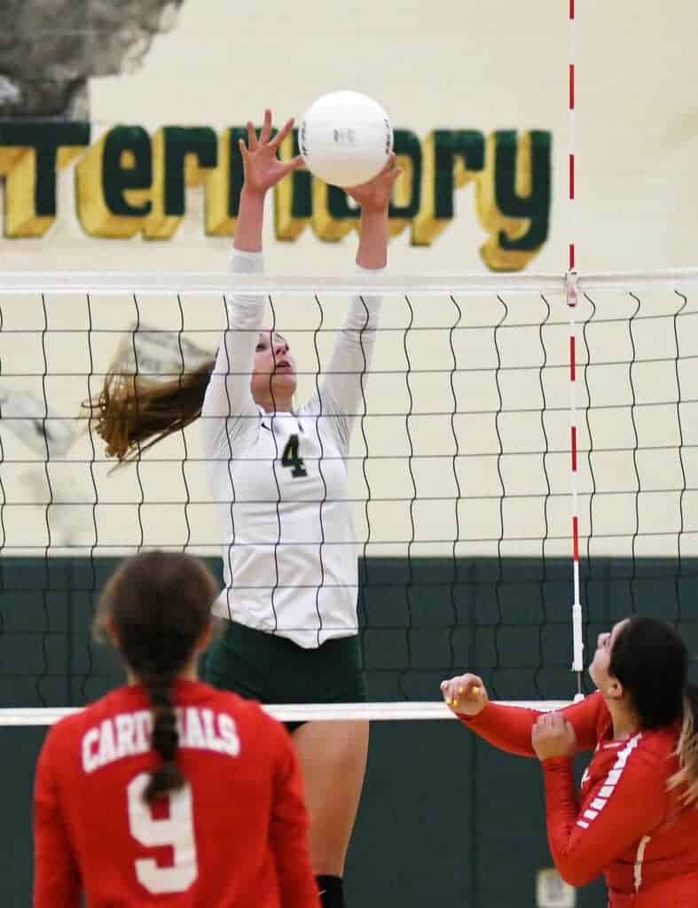 Photo - Liberty’s Hannah Chase rises up to block a Lindsay Cardinals attack during a three-set Div. IV first round victory Thursday.