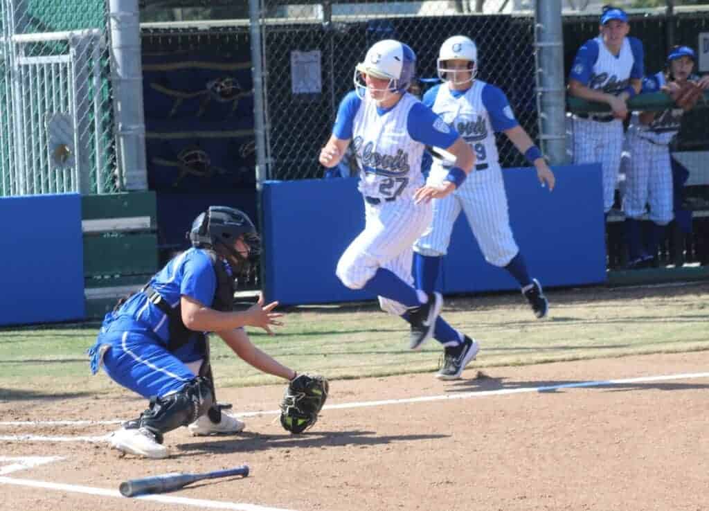 Photo - Madera catcher Nevaeh Montes gets ready to put the tag on Clovis’ Kaylynn Munoz during Saturday’s loss.