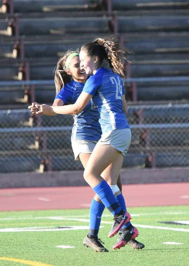 Photo - Madera’s Natlaia Mata (24) celebrates with Adela Alvarez after scoring the first of two gials in Thursday’s overtime win over San Joaquin Memorial.