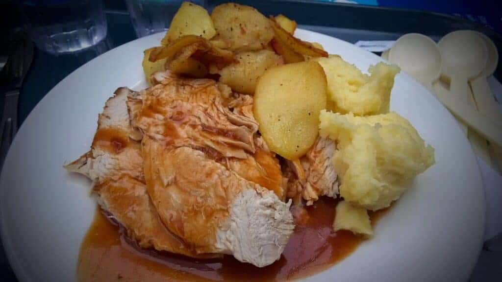 Photo - Slices of succulent roast turkey, enhanced with homemade gravy and some taters alongside.
