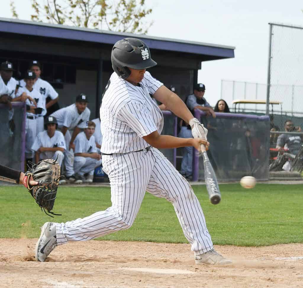 Photo - Madera South’s A.J. Rocha hits a single to right field during a three-run fourth inning. He came around to score the Stallions’ second run in Wednesday’s loss.