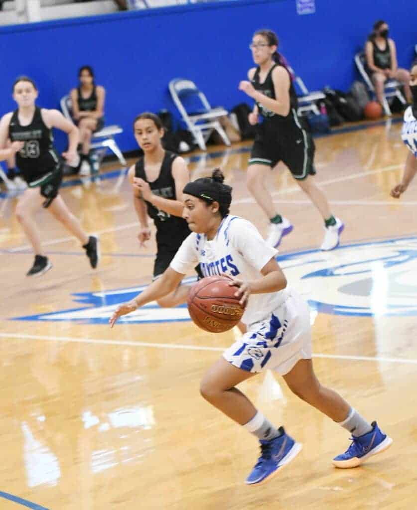 Photo - Madera’s Rhynne Mitchell drives to the hoop to score two of her team-high 14 points in Tuesday’s season opening victory over the Reedley Pirates.