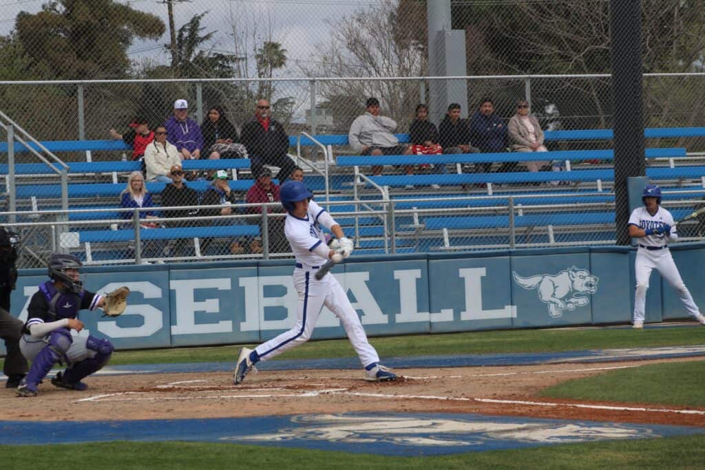 Photo - Madera’s Logan Wattenbarger connects on a first inning hit that allowed him to score the Coyotes’ lone run in Saturday’s 2-1 loss to Fresno.