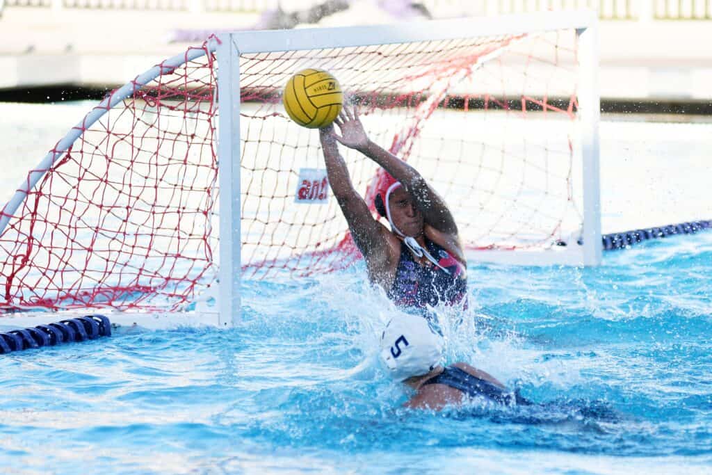 Photo - Madera South water polo goalie Jatzelle Salazar reaches up to block the shot of Madera’s Tara Goertzen (5) during Wednesday’s match.