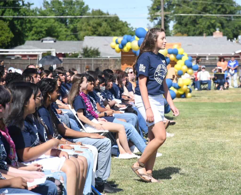 Photo - Tori Herd makes her way to the stage to receive an achievement award for being in the top 10 of her promoting class during the Thomas Jefferson Middle School promotion ceremony on June 3.