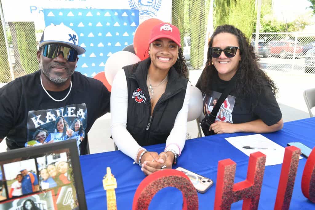 Photo - Madera’s Kailea Ricks, and her parents, are all smiles after she signed her National Letter of Intent to play next season at Ohio State. 