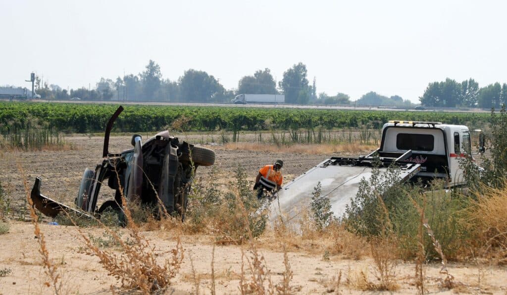 Photo - A wrecked 2005 Chevy Trailblazer sits on its side in a field Wednesday about 3 p.m. on Avenue 12 east of Road 29.