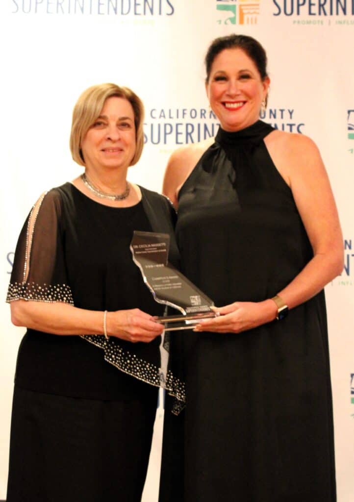 Photo - Madera County Superintendent of Schools Cecilia Massetti, left, stands with the Champion’s Award after receiving the honor at the California County Superintendents award dinner on October 17.