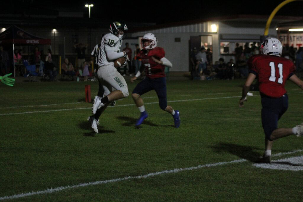 Photo - Liberty’s Anthony Gaitan hauls in a touchdown pass to tie the game in the first half of Friday’s loss to the Strathmore Spartans. 