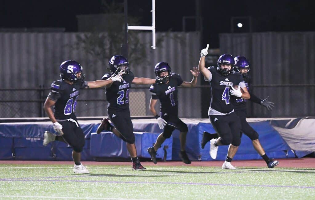 Photo - Madera South’s Sergio Garcia (4) gets an escort into the end zone for a fumble return for a touchdown. Celebrating with Garcia are, from left, Adrian Rodriguez, Angelo Moreno, Vincent Botello and Fabian Mendoza.