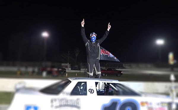 Photo - Thomas Stanford celebrates in victory lane after capturing Olga’s California Dream 100 in the Pro Mini Stocks race last week.